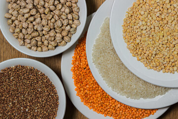 Various cereals on a wooden background. The concept of wholesome food. Vegetarian food