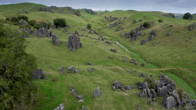 Aerial: Limestone outcrops and rugged farm landscape. Location used in the Lord of the Rings movie.  Waitanguru, Waikato, New Zealand