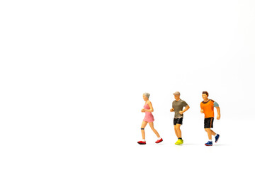 Fototapeta na wymiar Miniature people running on white background , Healthy lifestyle and sport concepts.