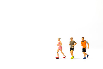 Miniature people running on white background , Healthy lifestyle and sport concepts.