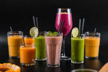 Bright and juicy photos of smoothies and fruit cocktails in the original presentation - obrazy, fototapety, plakaty