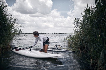 Windsurfer surfing on a windy summertime day at the river.