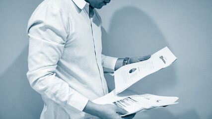 Young business man and digital number of stock market background to represent successful in...