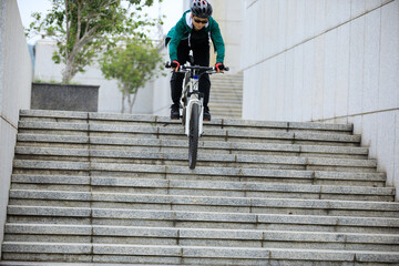 Woman freerider riding down city stairs