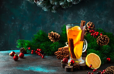 Hot winter tea drink, spicy cocktail with lemon, rum, cinnamon, anise. Rustic style, copy space....