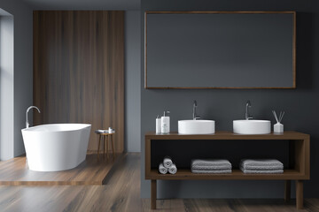 Fototapeta na wymiar Modern grey bathroom with oval white bathtub and dark wood details