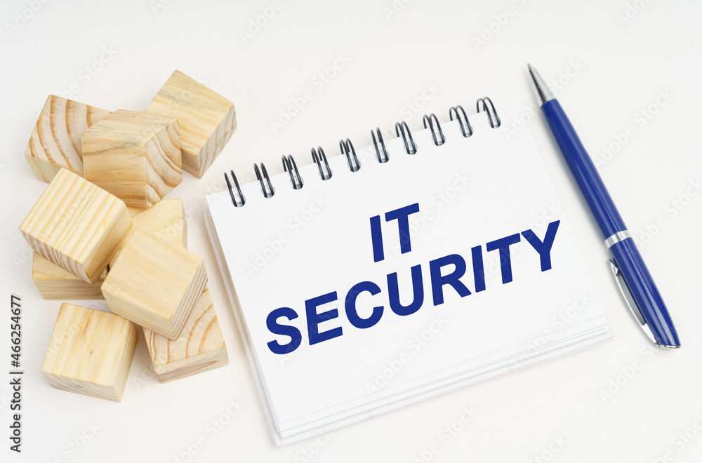 Poster on the table are cubes, a pen and a notebook with the inscription - it security