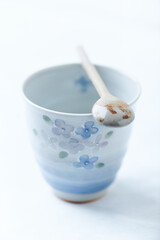 Traditional, handcrafted ceramic on bright wooden background. Soft focus. Close up.	