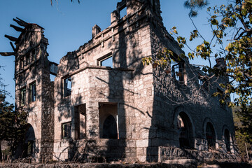 Abandoned and demolished old stone building. Selective focus.