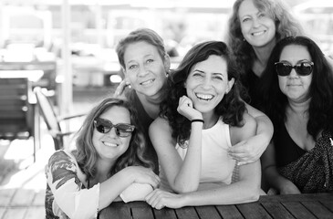 Women best friends sitting in summer cafe on the beach