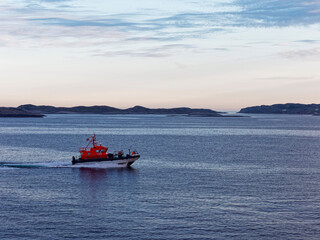 The Bergen Pilot Boat escorting a Vessel through the Fjord between the many small Islands that can be seen on the Norwegian Coastline.