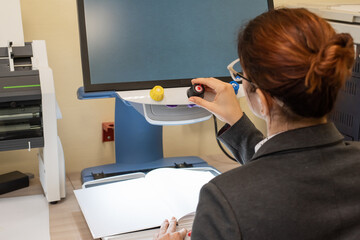 A visually impaired woman uses special reading equipment
