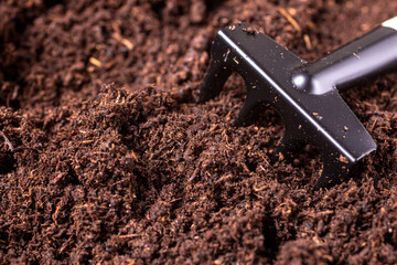 Mini garden rake with soil, dirt for gardening and planting, indoor plants