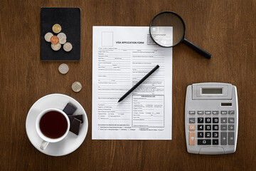 Visa application form on a wooden table, visa processing, registration, flat lay