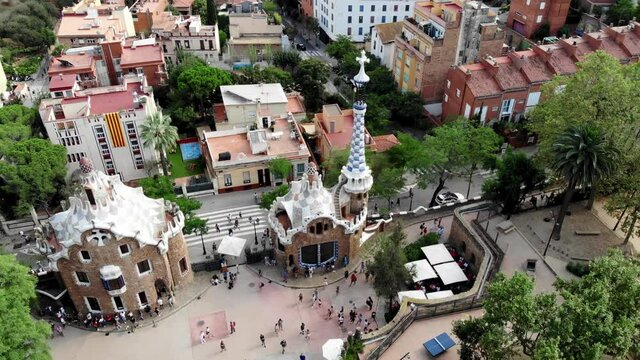 Drone shot Park Guell in Barcelona. Panoramic view of the city of Barcelona. Spain from drone. Park at the top of Barcelona. Drone view of gardens and residential areas in Spain.