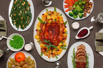 Festive dinner table concept with homemade food. Roasted chicken, potato, baked veal meat roll up,...