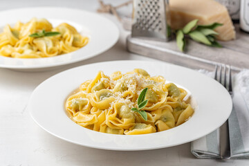 Lunch, tortelloni with spinach, ricotta and grated parmesan.  Stuffed pasta stir-fried with melted...