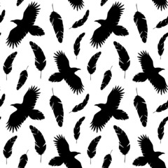 Fototapeta na wymiar Silhouettes of flying ravens and falling feathers black and white seamless pattern. Best for textile, wallpapers, wrapping paper, package and decoration.