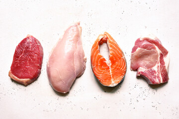 Different types of organic raw meat : beef, chicken, fish and pork. Source of protein. Top view .