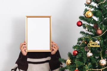 Woman holding mockup frame design for decoration Christmas day.