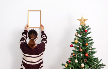 Woman holding mockup frame design for decoration Christmas day.