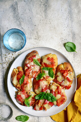 Grilled bruschetta with tomato and mozzarella . Top view with copy space.