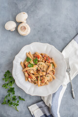 mushrooms pasta with fresh herbs and tomato sauce
