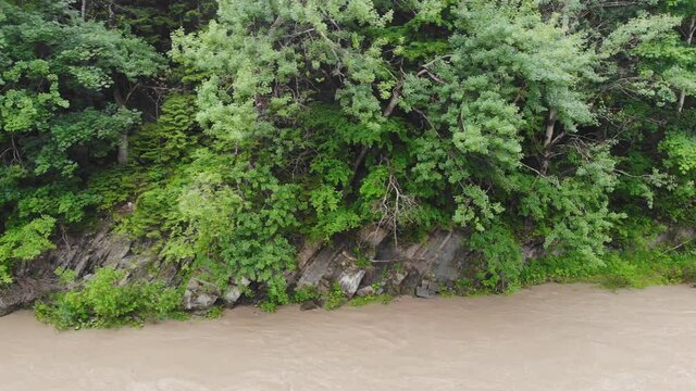 Mountain river after heavy rains. The water in the river is dirty from soil and stones. This situation is the forerunner of flooding in Europe.