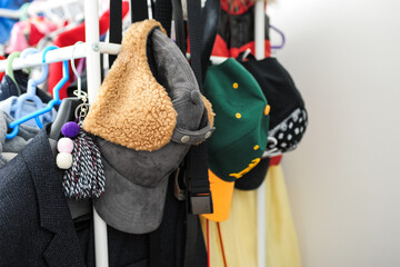 Naklejka premium hats hanging on hangers