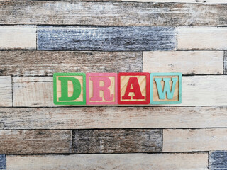 Draw. The word draw from wooden letter blocks. Fit for educational media, teaching, childrens book, etc