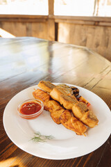 fish kebab on skewer with sauce on white plate on table.set table, vegan dish. selective focus