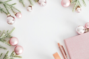 Elegant feminine table workspace with Christmas decorations and fir tree branches on white background. Flat lay, top view, copy space. Glamour home office desk. - obrazy, fototapety, plakaty
