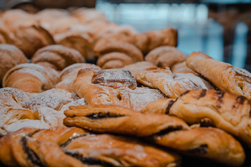 croissant, pot pocket, packed with filling. close up of delicious sweet dessert cake, in the window of a pastry shop.