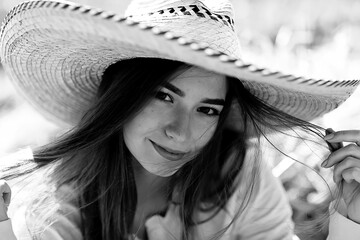 black and white portrait of a cheerful girl country style, freedom young female in a field of straw