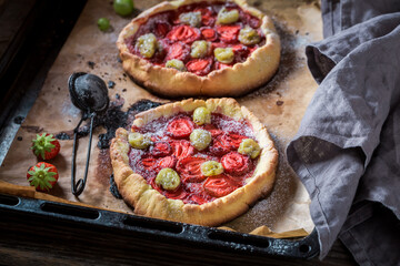 Homemade tart with gooseberries and strawberries Berries tart with sugar.