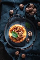 Tasty and sweet walnut cheesecake made caramel and nuts.