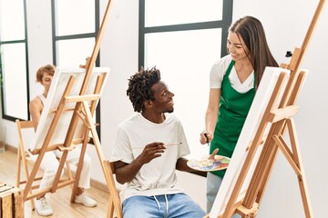 Group of people smiling happy drawing at art studio.