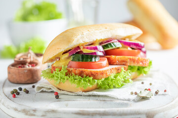 Homemade and healthy sandwich with grilled chicken, cucumber and tomato