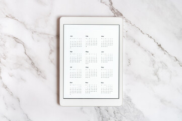 tablet computer with an open app of calendar for unspecified unknown date year without date on a...