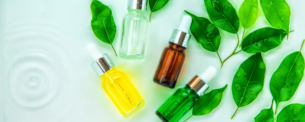 Cosmetics in a bottle in water, skin hydration concept. Selective focus.