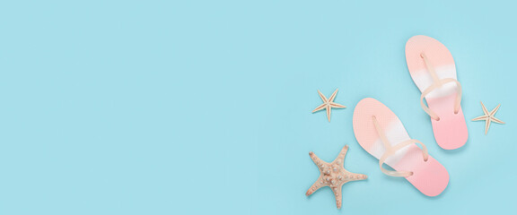 Beach flip flops, starfish on a blue background. Top view, flat lay. Banner.