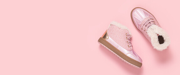 Fashionable baby shoes on a pink background. Top view, flat lay. Banner.