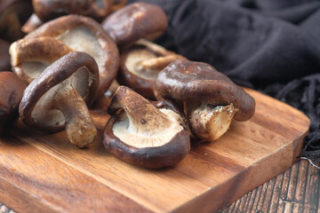 raw champignon mushroom on a chopping board on table 