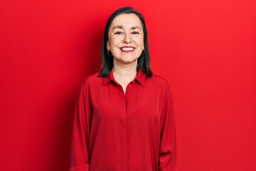 Fototapeta premium Middle age hispanic woman wearing casual clothes with a happy and cool smile on face. lucky person.
