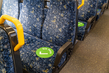 Sydney train carriage with stickers sit here on seats for social distancing during Covid-19...