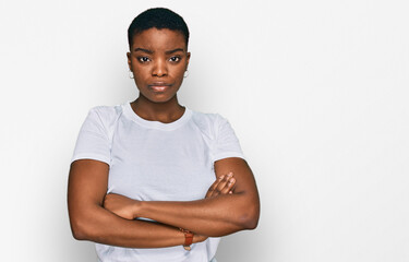 Young african american woman wearing casual white t shirt skeptic and nervous, disapproving...
