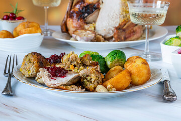 Traditional Christmas dinner with roasted turkey, apricot and pistachio stuffing, roast potatoes and cranberry sauce