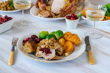 Traditional Christmas dinner with roasted turkey, apricot and pistachio stuffing, roast potatoes and cranberry sauce