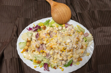 Caesar salad with wooden pallet to serve