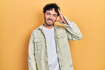 Young hispanic man wearing casual clothes confuse and wonder about question. uncertain with doubt,...